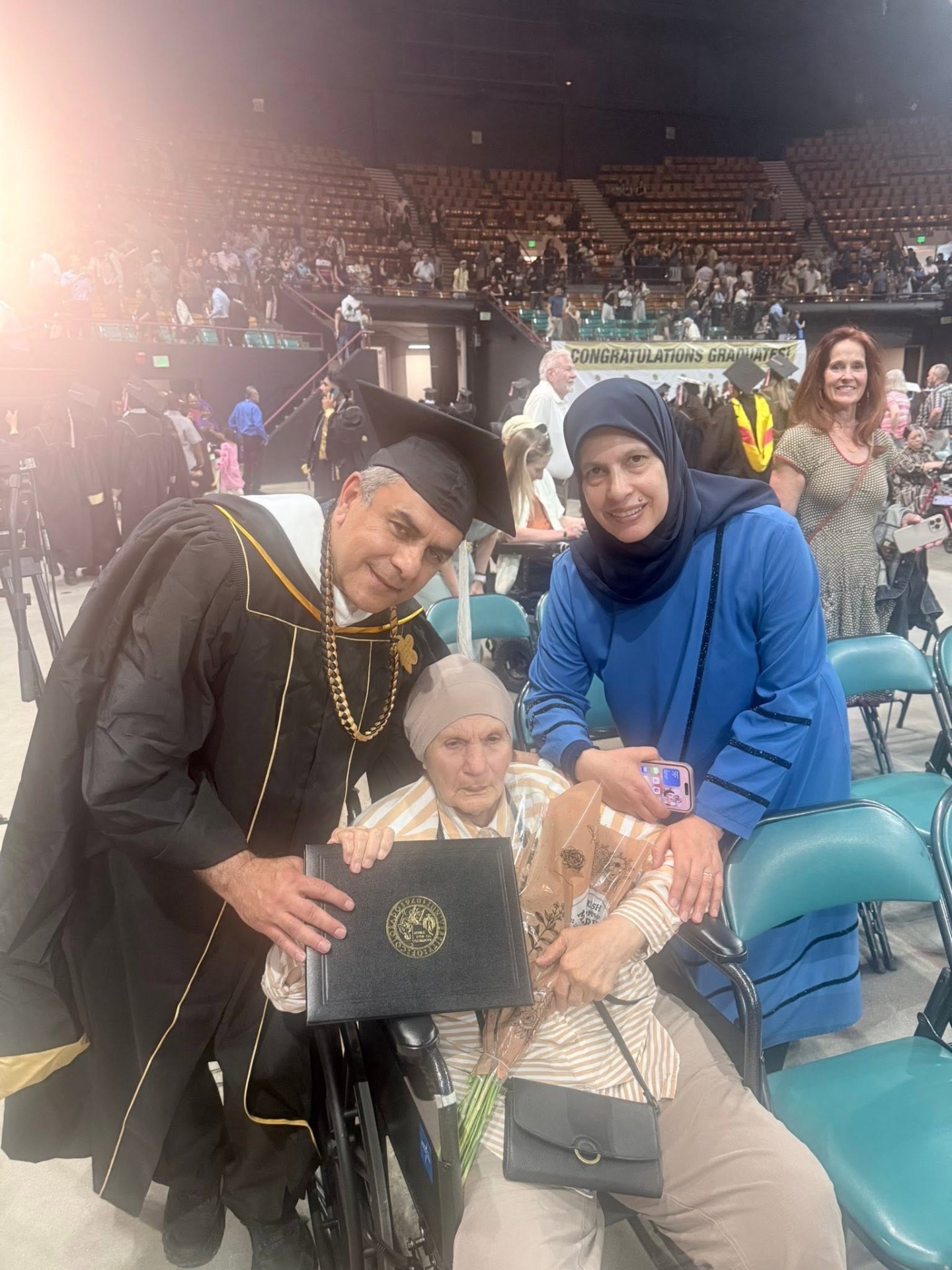 Ali Al Nazzal at his University of Colorado Denver graduation with his mother and wife
